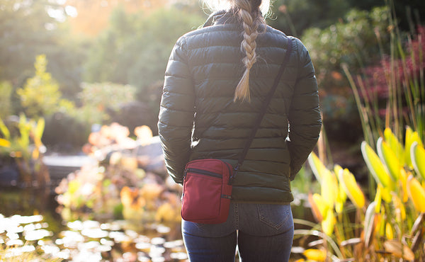 Person wearing a Everyday Cubelet in Mars Red at a Japanese garden.